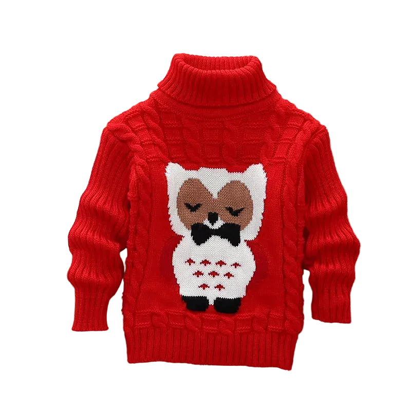 Red sweater with owl design on a wooden surface