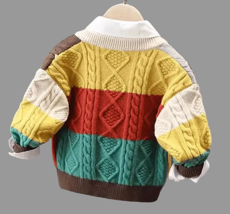 Colorful children's sweater on a hanger against a neutral background